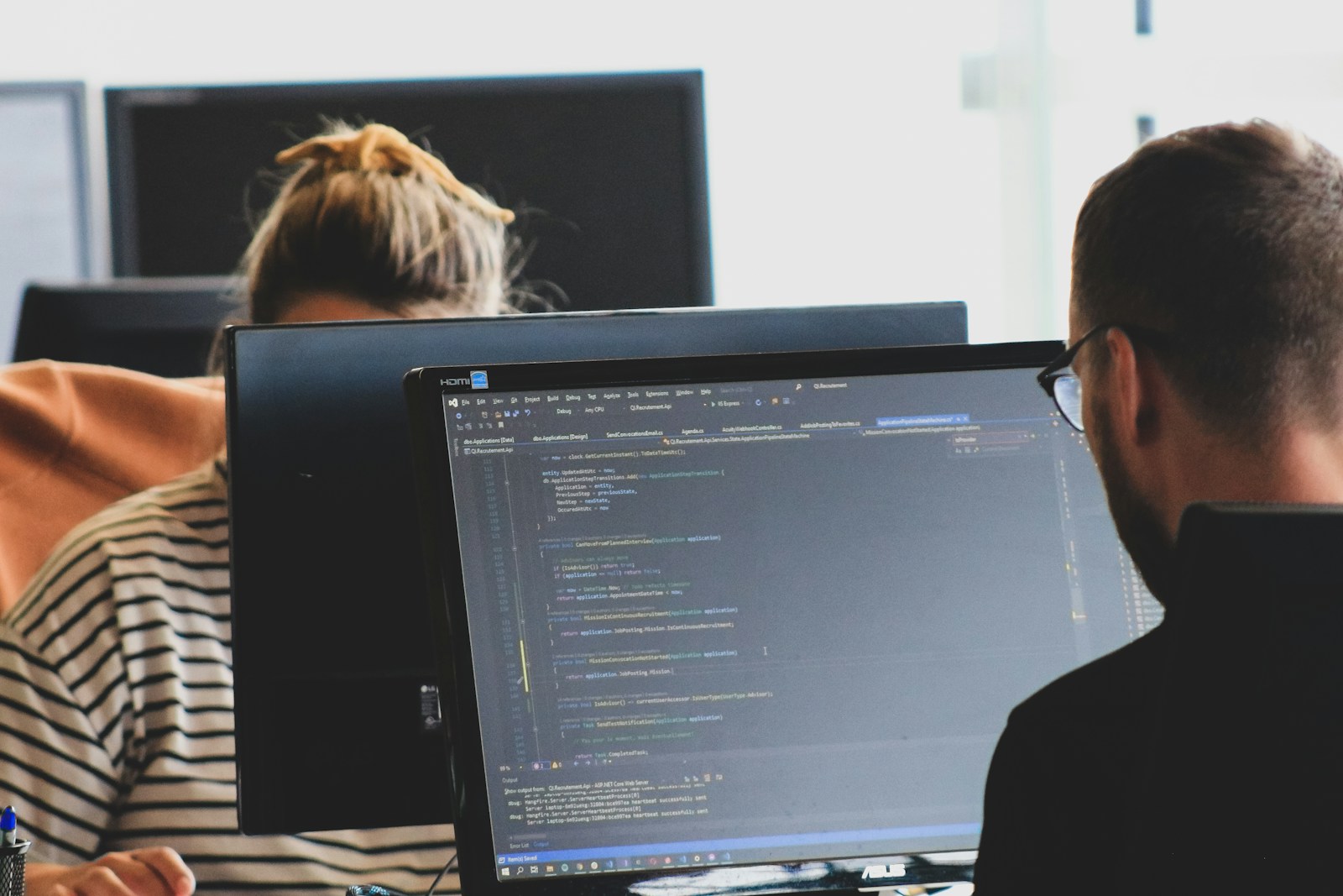 woman in black shirt sitting beside black flat screen computer monitor, cyber liability